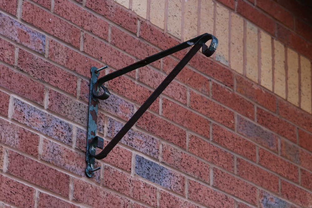 metal holder for hanging basket on outside wall