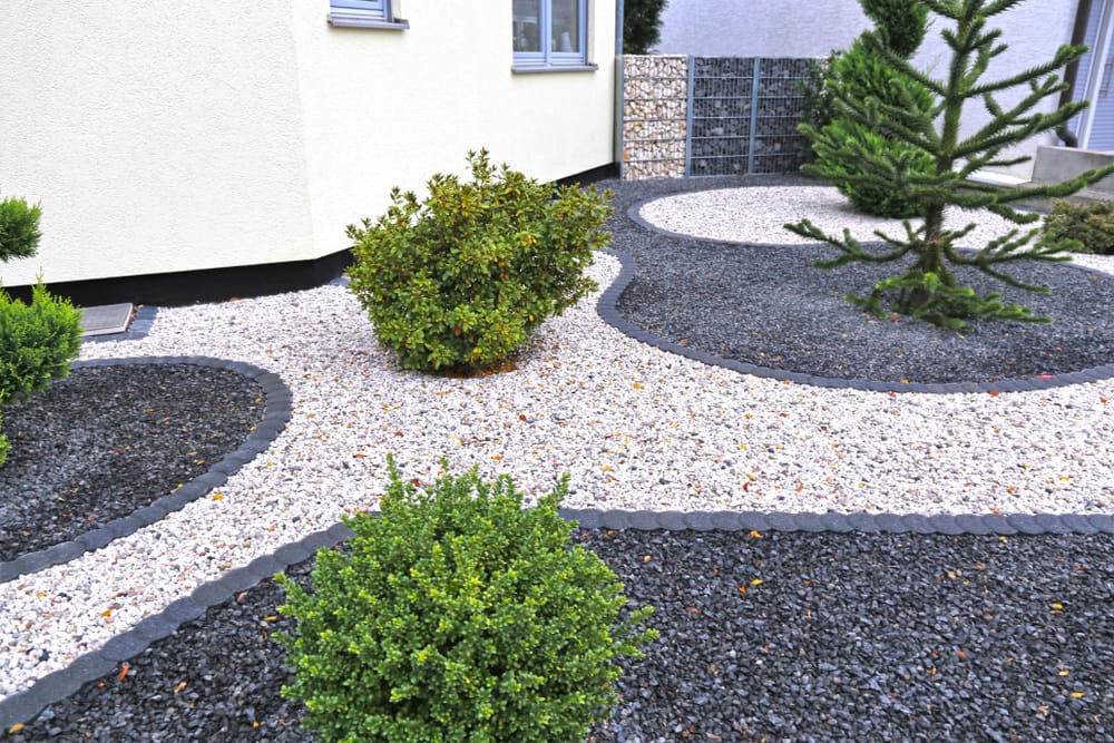 different colours of gravel with miniature shrubs