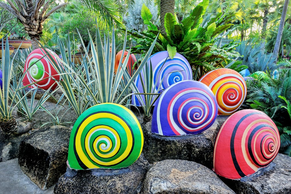 colourful snail sculptures in a garden