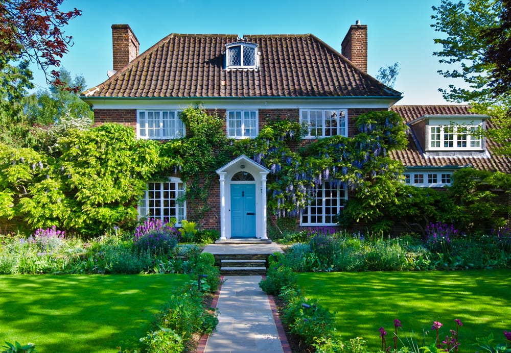 detached countryside home with beautiful front garden and a path leading to blue door